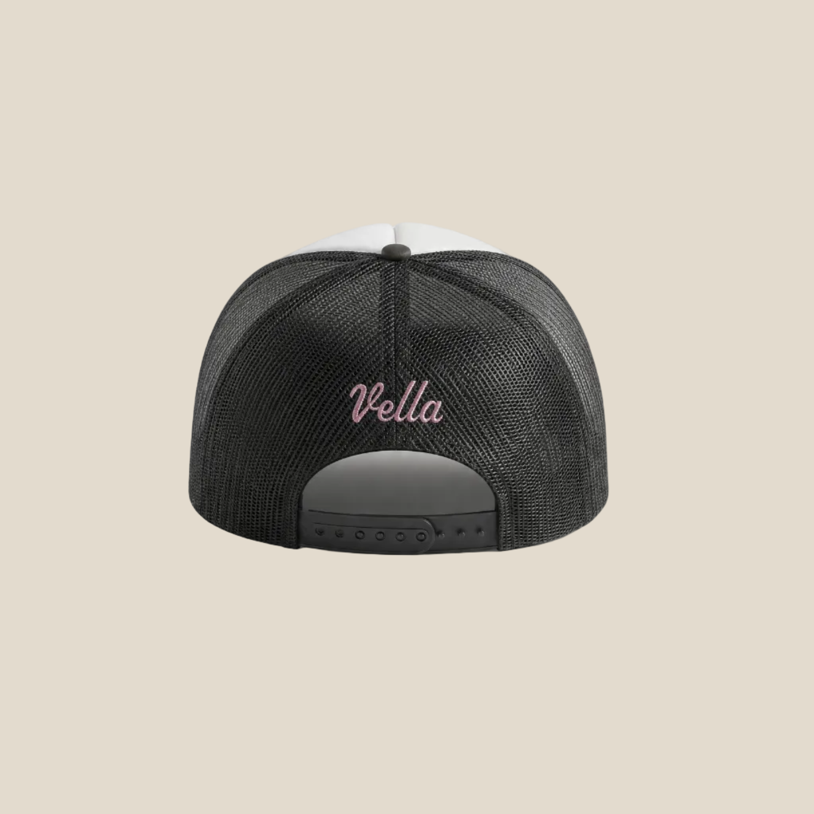 Black mesh cap with 'Vella' logo on a light beige background