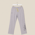 Gray sweatpants with yellow drawstring on a beige background