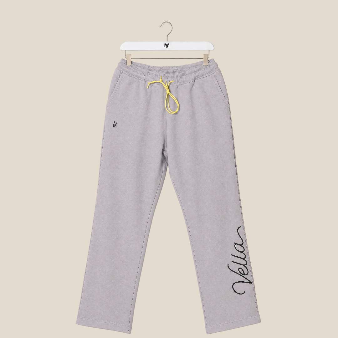 Gray sweatpants with yellow drawstring on a beige background