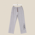 Gray sweatpants with 'Vella' branding on a beige background